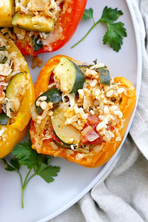 Vegetarian Italian Stuffed Peppers - a healthy stuffed peppers recipe with rice, zucchini, spinach, tomatoes, onion and finished with a crown of mozzarella cheese. #peppers #italian Spinach Peppers And Onions, Stuffed Peppers Recipe Vegetarian, Healthy Stuffed Peppers Recipe, Healthy Stuffed Peppers, Pepper Recipes Healthy, Recipe With Rice, Italian Stuffed Peppers, Vegetarian Stuffed Peppers, Veggie Patties