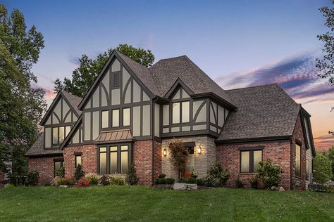 Board & batten exterior of modern Tudor-Style home in Chesterfield, MO Tudor Style Homes Modern, Mock Tudor House Exterior, Tudor Exterior Paint, Board Batten Exterior, Modern Tudor Home, Tudor Exterior, Tudor House Exterior, Tudor Manor, Tudor Homes