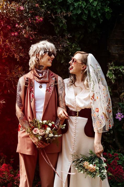 Couple in tanned waistcoat with embroidered flowers and button detail sleeveless wedding dress Masculine Wedding Dresses, Masc Fem Wedding, Masculine Wedding Outfit, Transmasc Wedding Outfit, Unconventional Wedding Outfit, Queer Wedding Attire, Queer Wedding Suit, Nontraditional Wedding Outfit, Queer Wedding Dress