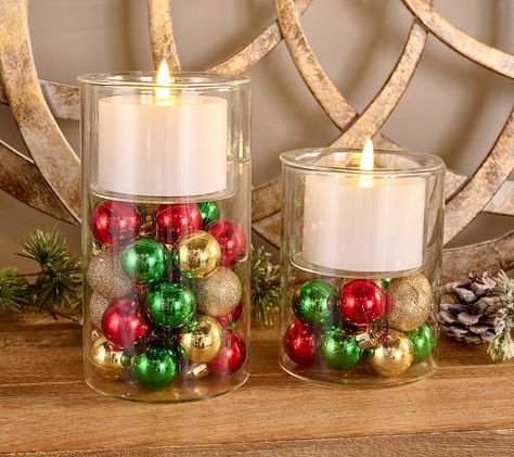 Add a touch of festive charm to your home with this Lightscapes set of two candle holders. These glass holders come with flameless candles, creating a warm and inviting glow without the hassle of real flames. Perfect for holiday decor, each holder features an assortment of ornaments for added cheer. From Lightscapes.    Original item is H466113. This product may be a customer return, vendor sample, or on-air display and is not in its originally manufactured condition. It may not be new. In some instances, these items are repackaged by QVC. Terra Cotta Pot Candle Holder, Present Centerpieces, Christmas Ornament Centerpieces, Holiday Party Centerpieces, Candle Play, Kwanzaa Crafts, Lodge Christmas, Inexpensive Diy Gifts, Christmas Gala