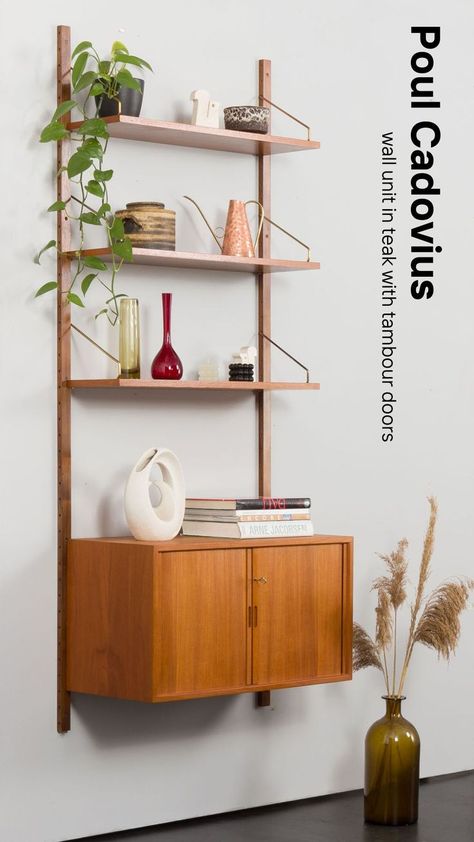 This sleek Poul Cadovius wall unit exemplifies the beauty of Scandinavian design. Made from rich teak with iconic tambour doors, this wall-mounted shelving system offers versatile storage solutions while adding a sophisticated, minimalist aesthetic to any interior. #PoulCadovius #TeakFurniture #ScandinavianDesign #WallUnit #ModularShelving #MidCenturyModern #DanishDesign #TambourDoors #VintageFurniture #FloatingShelves 1960s Chairs, Scandinavian Home Design, Tambour Doors, 50s Design, Modular Shelving, Danish Furniture, Vintage Dressers, Vintage Cabinets, Teak Furniture