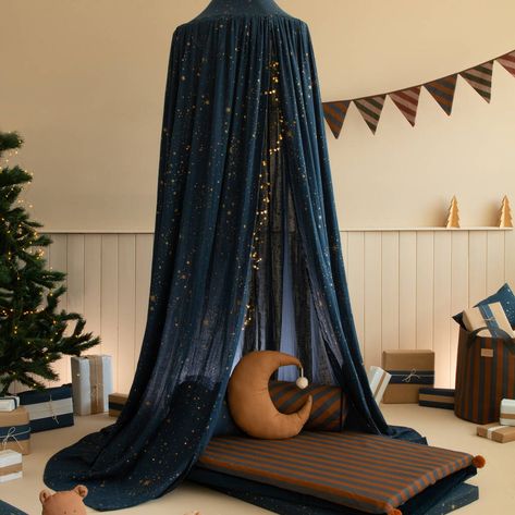 Create a magical fairytale-like environment in your child's bedroom with our Gold Stella / Night Blue Canopy. Made from double organic cotton muslin the floaty nature of the canopy makes it perfect for draping over a cot bed or bed.Finish with a string of LED lights as photographed ( not included ). not given 100% Organic Cotton / Œko-Tex class 1 certified fabric; Safe for kid's skin and the planet Bed Canopy For Boys, Velvet Bed Canopy, Dark Bed Canopy, Star Room Decor Bedroom Ideas, Night Themed Bedroom, Fairytale Room Aesthetic, Bed Canopy Aesthetic, Constellation Bedroom, Celestial Bedroom Aesthetic