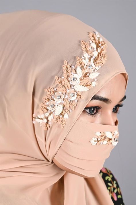 This Beige Instant Hijab comes with built-in/sewn magnets to secure the hijab under the chin. The hijab itself has beautiful threadwork done by hand. It doesn't come with a matching mask like shown in the 1st picture. It comes with a matching niqab that also has threadwork as shown in the other picture. The niqab has elastic, so it can be secured around your head. This set will also include a matching tie-back under cap. Perfect to wear to a casual event, wedding, party, or during Ramadan and Eid.  PLEASE NOTE: The inner side of this hijab has loose threads. Please reference pictures. Marked down from original selling price due to this defect. It is made from a georgette fabric that is lightweight. It is see-through and therefore a ninja-under cap is recommended. Measurements are about 66 Bridal Turban, Beige Luxury, Hijabi Brides, Georgette Material, Bridal Hijab, Head Coverings, Hijab Collection, Beige Wedding, Chiffon Shawl