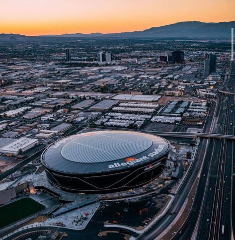 Allegiant Stadium in the bottom half of the photo with a sunset glow behind the mountains in the distance Vegas Trip Planning, Best Helicopter, Las Vegas Desert, Allegiant Stadium, Nfl Stadiums, Las Vegas Photos, Sports Stadium, Vegas Vacation, Valley Of Fire