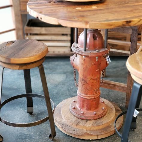 This is a one-of-a-kind table you won't find anywhere else! Built from an old fire hydrant, this bar table would look great in your basement or patio!  #ReclaimRenew #firehydrant #bar #basement #bartable #cool Fire Truck Bar Ideas, Firehouse Themed Bar, Firefighter Decor House, Old Fire Hydrant Ideas, Fire Hose Furniture, Fire Hydrant Table, Firehouse Decor Ideas, Fire Chief Office Ideas, Firefighter Room Man Caves