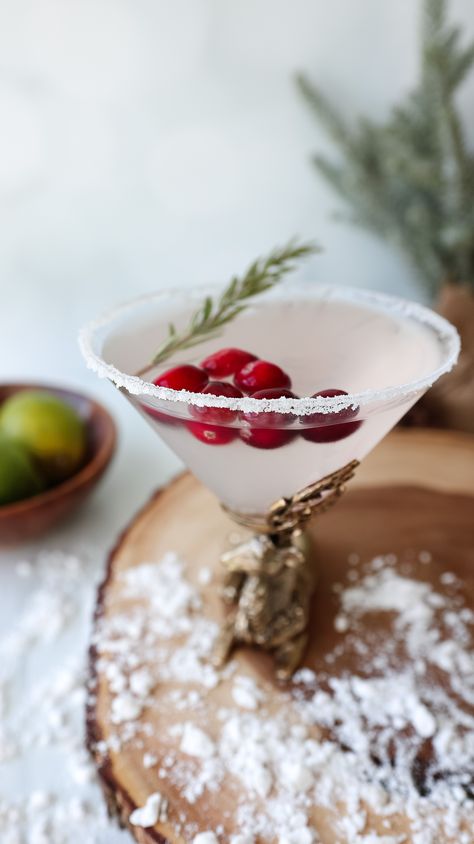 Winter White Cosmo White Christmas Cosmo, Christmas Cosmopolitan Drink, White Cranberry Mocktail, Pomegranate Holiday Cocktails, White Cranberry Cosmo, Christmas Wedding Drinks, Winter Bar Drinks, Winter Batch Cocktails, Winter Wonderland Drinks For Adults