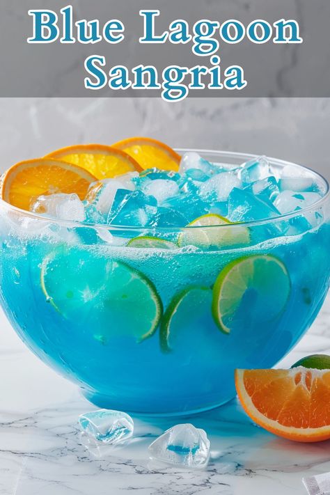 Blue Lagoon Sangria is a refreshing, vibrant cocktail that combines the crispness of white wine with the citrusy sweetness of blue curaçao and the effervescence of lemon-lime soda. Curacao Punch, Blue Alcoholic Drinks, Blue Curacao Drinks, Christmas Cocktails Easy, Easy Halloween Food, Blue Drinks, Yummy Alcoholic Drinks, Refreshing Drinks Recipes, Lemon Lime Soda