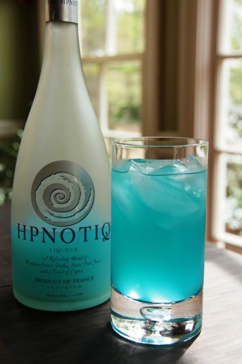 The Bimini Escape, a blue cocktail recipe that's the color of the ocean using rum and Hpnotiq, a liqueur made with exoctic fruits, cognac, and vodka. | Sumptuous Living | http://sumptuousliving.net/cocktail-fridays-biminy-escape/ Drinks Made With Hypnotic, Cocktails With Hypnotic, Hypnotic Liquor, Blue Martini Recipe, Hypnotic Drinks, Hpnotiq Drinks, Cognac Cocktails, Tropical Drink Recipes, Cognac Cocktail