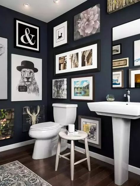 a navy bathroom with a gallery wall that takes all the blank wall space, white appliances and a mirror integrated into this art spot Small Bathroom Gallery Wall, Interesting Walls, 60s Bathroom, Bathroom Gallery Wall, Navy Bathroom, Paint Walls, Dark Bathrooms, Restroom Design, Bathroom Gallery