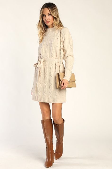 Bundling up for the season has never looked so fabulous thanks to the Lulus Warmed Up To You Cream Cable Knit Mock Neck Sweater Dress! Thick, cozy wool-blend cable knit shapes a mock neckline, long sleeves, and a relaxed bodice. The shift silhouette falls to a cute mini hem and features a tying belt that allows you to cinch the waist. Contrasting ribbed knit accents the neckline, cuffs, and hem. Fit: This garment fits true to size. Length: Mid-thigh. Size medium measures 32.5" from shoulder to h Neutral Sweater Dress, Fall Cream Dress, White Sweater Dress With Tights, Winter Church Dresses, Winter Proposal Outfit, Winter Picture Outfits, Cream Sweater Dress Outfit, Thanks Giving Outfits Women, Winter Photoshoot Outfits