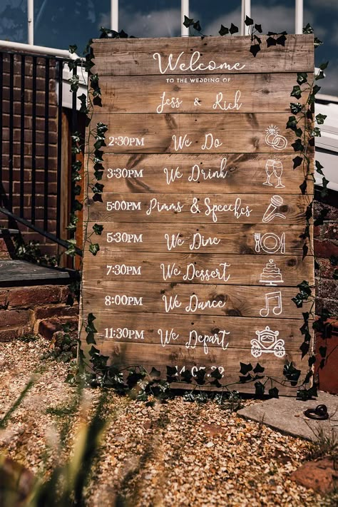 Wooden pallet board order of the day and welcome wedding sign with foliage decoration Wedding Pallet Timeline, Pallet Table Wedding, Welcome Sign And Order Of The Day, Wood Ideas For Wedding, Wooden Wedding Signs For Reception, Wedding Timeline Pallet Sign, Order Of Service Wedding Pallet, Rustic Order Of The Day, Order Of Service Pallet