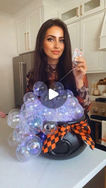 Muna Nijmeh on Instagram: "DIY BUBBLING CAULDRON!  Here is a simple and super cool DIY you can do for Halloween! Grab a plastic cauldron, and fill it up with some foam blocks. Start hot gluing some iridescent ornaments to the blocks and swooping down the side of the cauldron. I added some purple fairy lights before adding the ornaments but left slack so that I can wrap it around all the ornaments.  🧙‍♀️ SAVE THIS IDEA 🧙‍♀️  #halloweendecor #diyideas #dollartree #amazonfinds #halloweendecorations" Diy Halloween Calderon, Dollar Tree Cauldron Crafts, Cauldron Halloween Decoration, Halloween Caldron With Bubbles, Cauldron With Ornament Bubbles, Caldron With Bubbles, Bubble Cauldron Diy, Halloween Cauldron Diy, Bubbling Cauldron Diy