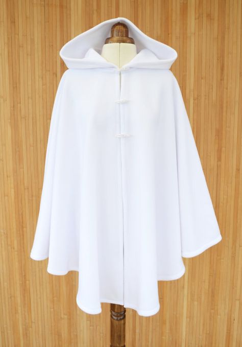 Envelop yourself in this pure white hooded cape, made from super soft fleece fabric and finished with three toggle buttons.  Standard size: fits 8 to 16 UK sizes/ 4 to 12 US sizes. Length 78cm / 31 inch Plus size: fits 18 to 22 UK sizes/ 14 to 18 US sizes. Length 86cm / 34 inch * If Bridal Cloak, Wedding Dress Cover Up, Cape Tutorial, White Cloak, White Cape, Cape Cloak, Cashmere Cape, Cape Wedding Dress, Chique Outfits