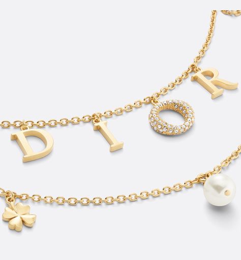 The Dio(r)evolution necklace has a distinctly modern aesthetic. Its gold-finish metal double chain is embellished with the Dior letters, while the letter O has a pavé of silver-tone crystals adding a touch of sparkle. Enhanced by a white resin pearl and emblematic Dior symbols such as stars, a clover and a bee. A sophisticated piece, the necklace can be combined with other creations from the Dio(r)evolution line.. Dior Letter Necklace, Dior Revolution Necklace, Doir Necklace, Dior Necklace Gold, Christian Dior Jewelry, Resin Pearl, Dior Necklace, Dior Jewelry, Stylish Glasses