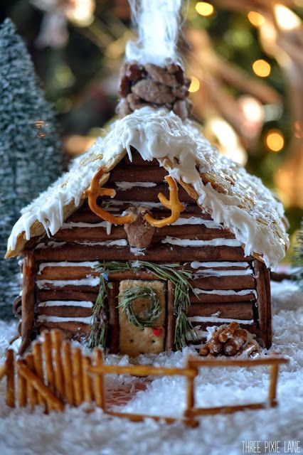 Three Pixie Lane: Gingerbread Log Cabin - I cannot stand how CUTE this is! Especially love the pretzel 'antlers'! Gingerbread Log Cabin, Homemade Gingerbread House, Gingerbread House Ideas, Ginger Bread House Diy, Cool Gingerbread Houses, Jul Diy, Gingerbread House Parties, Gingerbread House Designs, Gingerbread Party