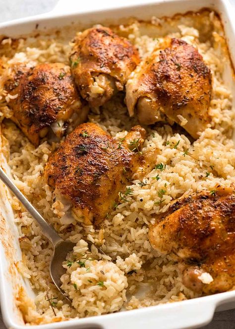 White baking dish with Oven Baked Chicken and Rice, ready to be served Chicken And Rice Baked In Oven, Oven Baked Chicken And Rice, Baked Chicken And Rice, Garlic Butter Rice, Rice In The Oven, Recipetin Eats, Recipe Tin, Baked Chicken Thighs, Oven Baked Chicken