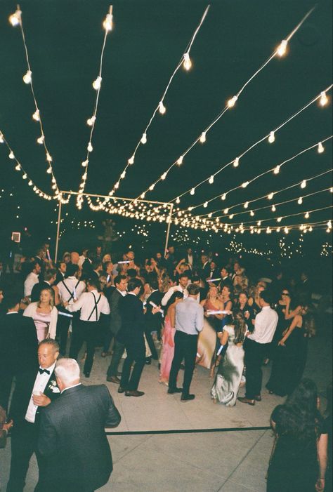 Wedding dance floors adorned with string lights create a magical and inviting atmosphere, perfect for celebrating under a soft, romantic glow. The twinkling lights suspended overhead add a whimsical touch, making the space feel intimate and enchanting. Combined with the lively energy of the dance floor, this setup brings warmth and elegance to any wedding reception. #WeddingDanceFloor #StringLightsMagic #RomanticWeddingVibes #EnchantedReception #WhimsicalWeddings #DanceUnderTheLights #MagicalWeddingNights #WeddingDecorGoals #TwinklingLights #ElegantWeddings Twinkle Lights Over Dance Floor, Outdoor Dancefloor, Wedding Dance Floors, Wedding Reception Dance Floor, Wedding Dance Floor, Dancing Wedding, Wedding Reception Lighting, Dance Floor Wedding, String Lights Wedding