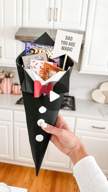 Mimi Markopoulos on Instagram: "🖤Father’s Day DIY - Paper Tuxedo Cone🤍 .  Stumbled upon this adorable DIY project by the talented creator @bellarteskids on TT and instantly felt inspired to give it a go, especially since I had all the necessary materials on hand! This simple yet charming DIY idea is ideal for crafting the perfect Father’s Day gift vessel.  The lovely Father’s Day print I used is from @oliveandeveco! Their collection of printables for various holidays is simply amazing, and at just $5, O&E offers fantastic options to elevate your gifts and decor. 😍 . More Father’s Day DIY ideas coming up 🤍🤍 . . . . . . #fathersday #fathersdaydiy #fathersdaygift #craftymom #girl@im #mdblogger #mdgirlmom #makeitwithmichaels #cardstockcrafts #cardstock" Fathersday Gift Diy, Fathers Day Gifts Ideas From Kids Diy, Fathers Day Activities For Kids, Fathers Day Decoration Ideas, Diy Father's Day Gifts Easy, Fathersday Gift Ideas, Diy Father's Day Decorations, Fathers Day Activities, Balloon Bar