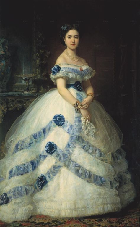 The Marquesa wears a spectacular half-dome shaped dress with a natural waistline set off by belt in this 1868 Madrazo y Kunz portrait. Tulle can be used dramatically in evening dresses as the Marquesa and her designer apparently knew. The bands of blue around her skirt are under the tulle, but the rosettes are above it. Moda Medieval, Istoria Modei, Gaun Abad Pertengahan, Historical Gowns, 1860 Fashion, Seni Vintage, 19th Century Fashion, Old Dresses, Antique Dress