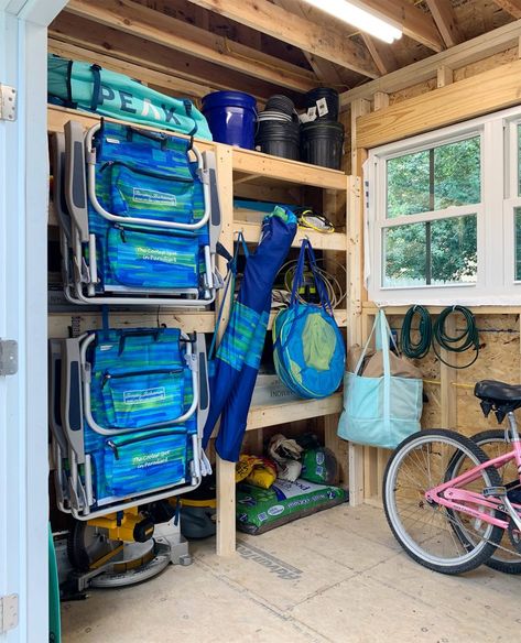 Beach House Storage Shed, Beach Storage Garage, Beach Stuff Organization, Beach Equipment Storage, Dock Storage Ideas Lake Houses, Organize Beach Stuff In Garage, Beach House Garage Ideas, Outdoor Beach House Decor, Beach House Yard Ideas