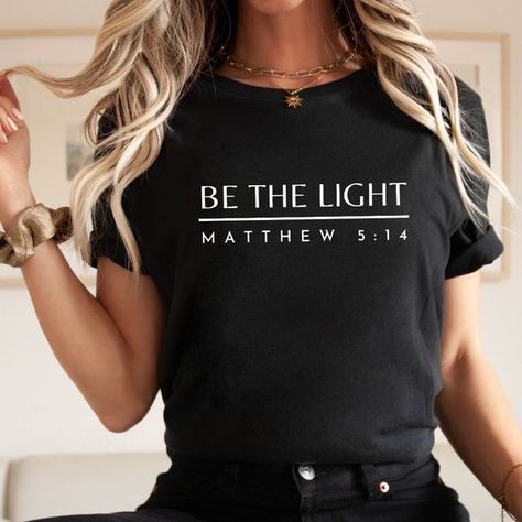 Be The Light Tee - Black / L T shirt #tshirt t-shirt #t_shirt t shirts #tshirts t-shirts #t_shirts T shirt design #tshirtdesign T-shirt designs #t_shirtdesign T shirts designs #tshirtsdesigns 6.84 Christian Tshirts Designs Woman, Christian T Shirt Ideas, Bible Verse T Shirt, Womens Christian Shirts, Christian Tee Shirts, Bible Shirts, Spiritual Shirts, Church Shirt, Faith Clothing