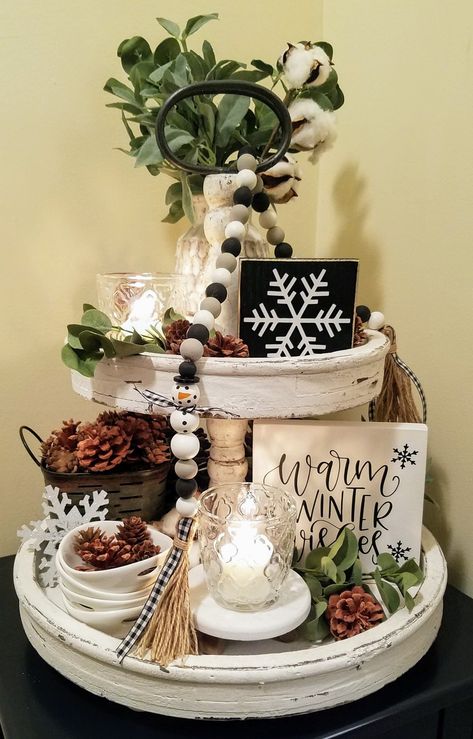 #winter #snowflakes #tieredtray #pinecones #cozy #snowman #tieredtrayideas #rustic #farmhouse Winter Kitchen Island Centerpieces, Farmhouse Winter Tiered Tray Decor, Winter 3 Tiered Tray Ideas, Decorating With Snowmen For Winter, Winter Two Tier Tray Decor, Snowman Winter Decor, Tiered Tray Decor Winter, Snowman Tiered Tray Decor, January Tiered Tray Decor