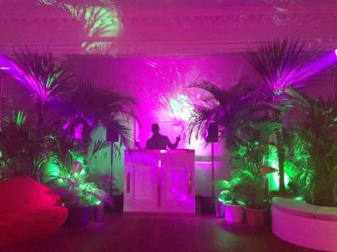 DJ booth set in jungle themed party. Jungle Dj Booth, Techno Theme Party, Neon Jungle Party Decorations, Neon Dj Booth, Tropical Dj Booth, Techno Party Decoration, Dj Themed Birthday Party, Neon Jungle Aesthetic, Tropical Neon Party