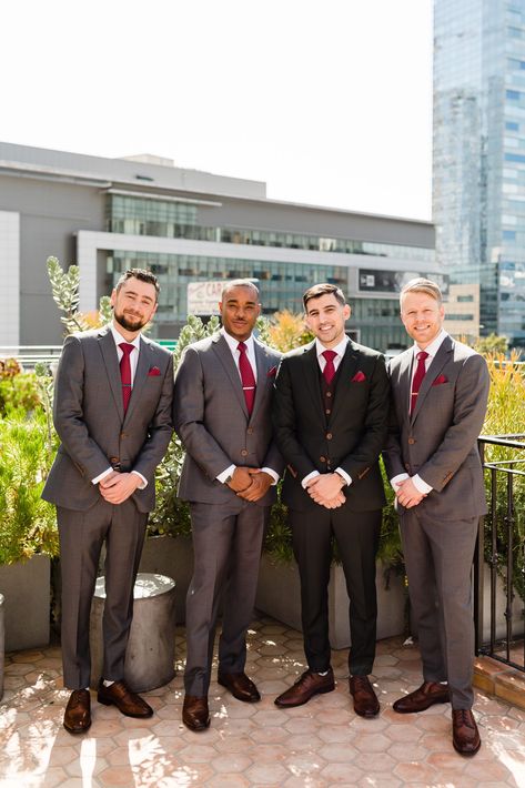 Groom with his groomsmen wearing dark grey suit and red tie getting ready for a spring wedding at Hotel Figueroa #colorfulweddingplanner #springwedding #downtownlosangeleswedding Groomsmen Attire Red Tie, Gray Suit Red Tie, Red Wedding Groomsmen, Red Tie Outfit Men, Red Groomsmen Attire, Grey Suit Red Tie, Red Groomsmen, Black Suit Red Tie, Suit Red Tie