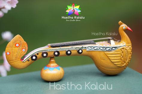 Bobbili veena is a large plucked string instrument used in Carnatic classical music. In 2011 the musical instrument got a Geographical Indication tag from the Government of India. Craft Type         Bobbili Veena Dimensions            9.5 x 2.5 x 3.5 (Inches) Product OriginBobbili Material                Wood Weight                 430 Grams >Bobbili Veena enjoys the status of a royal instrument. > Made from pure jackfruit wood > Decorative Showpiece- Does not play sound >The sound of the Bobbili or Ekanda Veena is more melodious than veenas having more joints. Bobbili Veena is considered to be invented in Bobbili of Vizianagaram district, Andhra Pradesh. The making of the Veena started in the 17th century during the reign of Pedda Rayudu. At that time, playing Veena was a common Miniature Gift Ideas, Veena Instrument, Modern Chess Set, Indian Musical Instruments, Eagle Drawing, Mid Century Minimalist, Indian Music, Music Instrument, India Colors