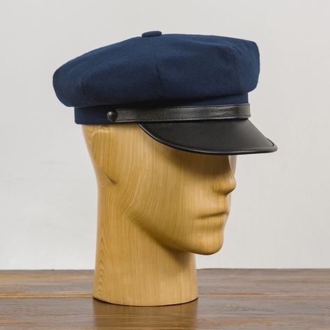 A vintage navy blue and black motorcycle cap. Made of high quality and skin friendly materials: woolen cloth crown, leather visor, breathable viscose lining, natural leather sweatband. A timeless, elegant and comfortable headwear modeled on the biker cap worn by Marlon Brando in the cult movie ''The Wild One''. It has a decorative belt above the bill with 2 matching oxidized finish buttons on each side and a gray decorative button on top of the crown. We make the cap in two different versions of Blue And Black Motorcycle, Cloth Crown, Rocker Fashion, Peaked Hat, Cult Movie, Vintage Biker, Black Motorcycle, Rocker Style, Marlon Brando