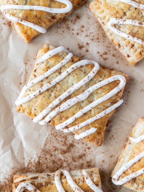 Looking down on a cinnamon roll pop-tart with vanilla icing and cinnamon sprinkled on top Pop Tart Pie, Pie Crust Cinnamon Rolls, Homemade Cinnamon Roll, Cinnamon Sugar Recipes, Cream Cheese Puff Pastry, Poptart Recipe, Puff Pastry Filling, Sugar Recipes, Tart Filling