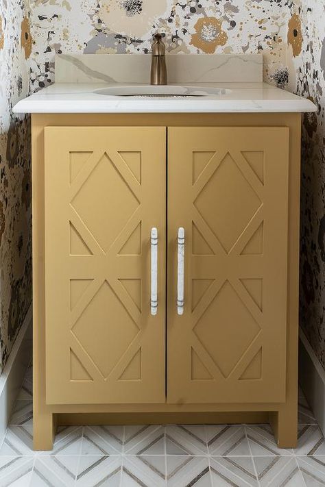 Charming yellow and gray powder room features a mustard yellow washstand placed on white and gray marble diamond pattern floor tiles and accented with diamond doors and a marble-like quartz countertop. Mustard Yellow Powder Room, Yellow Bathroom Vanity, Gray Powder Room, Pattern Floor Tiles, Floating Sink Vanity, Grey Powder Room, Powder Room Wall Decor, Chic Powder Room, Antique Brass Faucet