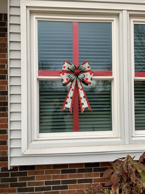 Christmas window decorating. This worked great this year. Held on with packing tape. Bow from Joannes. Used led tape lights around edge of window in warm white. Used on inside facing out. Didn’t use the adhesive on back but used packing tape to stick them on. They lay perfectly straight. Bows On Windows Christmas, Window Bows Christmas, Christmas Bows On Windows, Window Decorating, Medical Office Decor, Bow Window, Led Tape, Christmas Outdoor, Xmas Lights