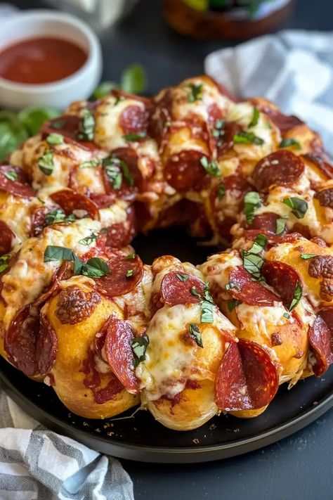 Pizza Monkey Bread: Gooey cheese, pepperoni, and seasoned dough baked to perfection. Perfect for sharing. Try this easy recipe today! Pepperoni Pizza Bread Pillsbury, Pepperoni Pizza In Bunt Pan, Company Snack Ideas, Appetizers With Bread, Pizza Ring With Pizza Dough, Recipes Using Bread Dough, Savory Monkey Bread Recipe, Pepperoni Bread With Pizza Dough, Baked Pickles And Cheese