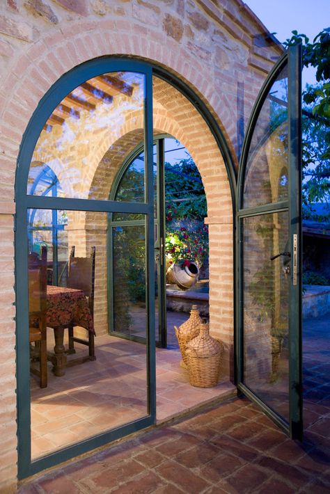 Arch, glass, brick, al fresco Arched Metal And Glass Door, Arch Exterior Door, Barn House Architecture, Glass Arch Door, Arched Glass Doors, Brick Villa, Arch Doors, Arch Door, Arch Window