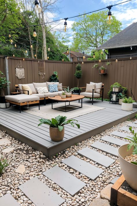 ground level deck in yard with sofa, rug and hanging lights Deck With One Step Down, Ground Deck Ideas Backyards, Ground Deck, Paver Deck, Side Patio, Small Patio Design, Patio Remodel, Backyard Layout, Backyard Seating Area