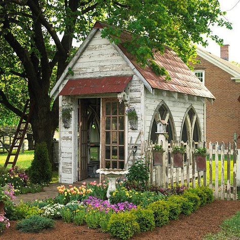 Gothic arched windows add to the antique feel of this garden shed. Stamped-metal roofing and hanging planters on the fence repeat the arched shape. A row of boxwoods brings order and definition to the entry garden. Shed Inspiration, Shed Decor, Gothic Garden, Backyard Vegetable Gardens, Meteor Garden 2018, Garden Wallpaper, Backyard Sheds, Backyard Shed, Potting Sheds