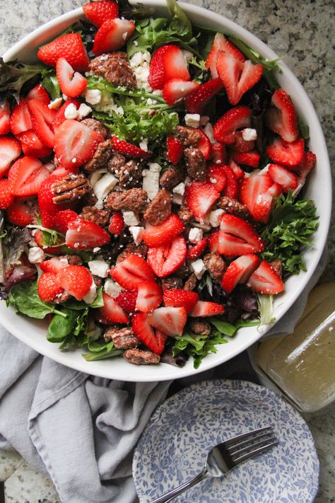 The homemade dressing and abundant toppings makes this Strawberry Pecan Feta Salad the yummiest addition to any meal! Easily tossed together in about 15 minutes. Candied pecans, fresh strawberries, feta cheese, & a homemade poppyseed dressing will make this your new favorite salad! This strawberry pecan feta salad is my go-to salad. Ask any of my friends, and almost all of them have had it at some point. I bring it everywhere, and I often serve it when people come over. It goes with almost every Homemade Poppyseed Dressing, Strawberry Fields Salad, Strawberry Feta Salad, Salad With Homemade Dressing, Candied Pecans For Salad, Strawberry Vinegar, Strawberry Feta, Crusted Chicken Tenders, Glazed Pecans