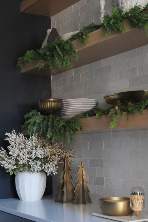 christmas-decor-oak-floating-shelves-black-cabinet-pantry Christmas With Black Decor, Holiday Floating Shelf Decor, Modern Christmas Decor Kitchen, Black Accent Christmas Decor, Black Kitchen Christmas Decor, Kitchen Open Shelving Christmas Decor, Christmas Kitchen Shelves Decor, Black Vase Christmas Decor, Modern Kitchen Christmas Decorations