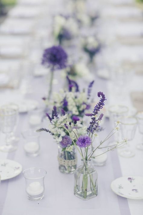 Purple Chiffon Table Runner, Lilac Wedding Flowers Table, Purple Simple Centerpieces, Purple Flower Table Decorations, Rustic Spring Wedding Centerpieces, Houseplant Wedding Table Decor, Lavender And Eucalyptus Wedding Centerpieces, Lavender And Silver Table Setting, Lavender Flower Wedding Decor