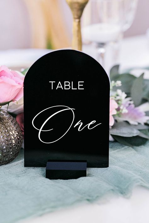 "Click on the following link to browse HUNDREDS more designs in our shop!! https://pinkposiesandpearls.etsy.com/  Black, White, Clear Frosted ARCH Acrylic Table Number Sign With Stands, Perspex Modern Calligraphy Table Numbers, Lucite Minimalist Number  | Welcome to Pink Posies and Pearls Wedding and Gift Boutique | We love the sleek, clean lines of these ARCH acrylic table number signs. This acrylic is a display material that is strong, moisture resistant & visually clearer than glass, not to mention shatterproof! Choose between 4x6 or 5x7. | TO ORDER | *These table number signs are 1/8\" thick and can be printed on white, black, clear or frosted acrylic. Simply choose your quantity of table numbers and stand choice. These are printed using our modern font, vertical orientation and will b 4x6 Table Numbers, Table Numbers Wedding Black And White, Black And White Table Numbers Wedding, Black Table Numbers Wedding, Perspex Table Numbers, Table Numbers Black And White, Glass Table Numbers, Black And White Table Numbers, Black Table Numbers