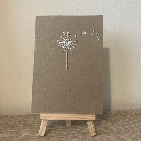 Beautiful handmade embroidered card. This A6 card features a minimalist, embroidered dandelion. The inside is blank for your message and the stitching is covered on the inside front.  Perfect for a thinking of you, sympathy card, birthday card and more occasions.   Envelope included.  Exact measurements of card are 10.5cm by 14.9cm. Sympathy Cards Handmade Simple, Embroidered Christmas Cards, Embroidered Dandelion, Old Wood Projects, Embroidered Cards, Embroidered Paper, Sympathy Cards Handmade, Daisy Cards, Embroidery Cards