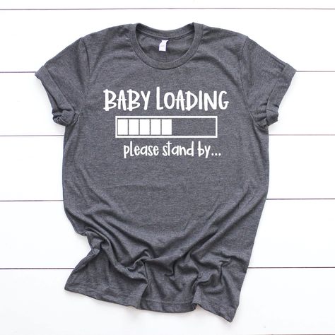 "This pregnancy announcement listing is for one bella canvas unisex pregnancy T-shirt. This shirt is the perfect shirt for your baby announcement or pregnancy reveal. Its also the perfect new mom gift, baby shower gift or maternity gift.  + This shirt is a unisex shirt, not a maternity shirt. Unisex shirts have a \"boyfriend fit\" which works well for pregnant women in their first and second trimesters. Order your normal size for a casual looser fit, size down if you would like a slimmer fit. Al Vinyl Clothes, Baby Loading, Fun Baby Announcement, Baby Announcement Shirts, Cricut Baby, Baby Birth Announcement, Baby Announcements, Pregnancy Announcement Shirt, Maternity Shirt