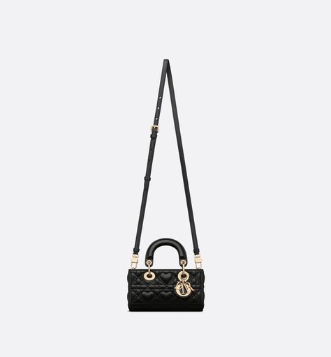 Part of the Dioramour capsule, the Lady D-Joy micro bag captures the House's vision of elegance and beauty by showcasing the iconic streamlined aesthetic of the Lady Dior line. Crafted in black lambskin with Cannage stitching elevated by a heart motif, the design is adorned with detachable pale gold-finish metal D.I.O.R. charms. Featuring one removable chain strap and another adjustable and removable leather strap, the Lady D-Joy bag can be carried by hand, worn over the shoulder or crossbody as Lady D Joy Bag, Black Designer Bags, Lady D, Dior Star, Icon Shoes, Micro Bag, Dior Book Tote, Heart Motif, Star Shoes