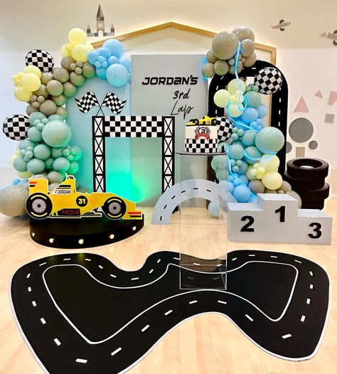 Race car-themed backdrop with checkered flags and race track decorations Third Birthday Race Car Theme, Track Decorations, Racing Car Birthday Party Ideas, 3rd Birthday Party Themes, Race Cars Birthday, Birthday Party Themes For Boys, Race Car Themes, Race Car Birthday Party, 3rd Birthday Party