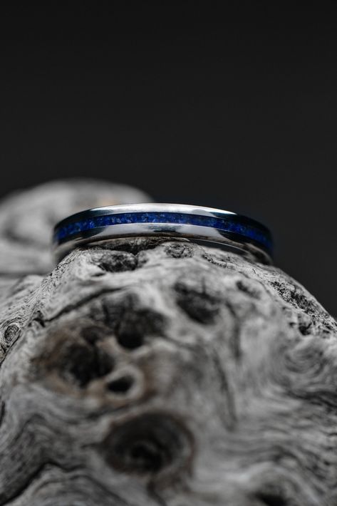 A thin titanium wedding band with a lapis lazuli inlay. The ring is setting atop a piece of gray driftwood. Fit At Home, Engagement And Wedding Rings, Titanium Ring, Wide Ring, Wide Rings, Titanium Rings, Making Waves, Inner Peace, Positive Energy