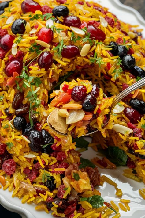 Colorful rice pilaf garnished with dried fruits, nuts, and herbs. Persian Cranberry Rice Pilaf, Jewel Rice Persian, Persian Rice And Chicken, Lebanese Hashweh Rice, Jeweled Rice Recipe, Jeweled Rice Persian, Persian Dishes Recipes, Middle Eastern Rice Dishes, Beetroot Rice Recipe