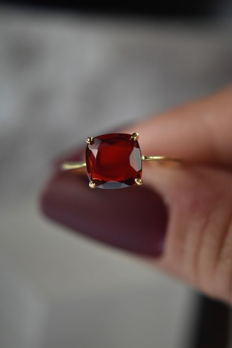 -------------------------------------------------------- Garnet Ring THE PRODUCT - This is a handcrafted genuine and natural raw garnet gemstone ring. - We select each stone individually, picking those that have a cherry red color and are apx. 3 cts. - The stone is tablet cut to show off all it's unique imperfections and beautiful shades of red it is also transparent. - Each stone has different markings and tones reminding you that not only is this truly a piece of the earth but it is one of a k Simple Gemstone Rings, Garnet Jewelry Aesthetic, Two Stone Ring Ideas, Gomed Stone Ring For Women, Square Ring Designs, Ruby Ring Designs Unique, Garnet Birthstone Rings, Unique Garnet Ring, Raw Stone Rings