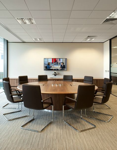 Board Room >> Circular Meeting Room Table >> This round wooden table in the boardroom at Amey creates a perfect collaborative space for colleagues. People often prefer the increased eye-contact you get when seated at a round table, and the more egalitarian nature of not having someone sitting at the head of the table. See more of the collaboration areas and meeting spaces we created at Amey on our website... Conference Room Round Table, Circular Office Table, Board Room Design Office, Round Table Meeting Room, Round Meeting Table Office, Office Round Table, Round Table Office, Board Room Design, Round Office Table