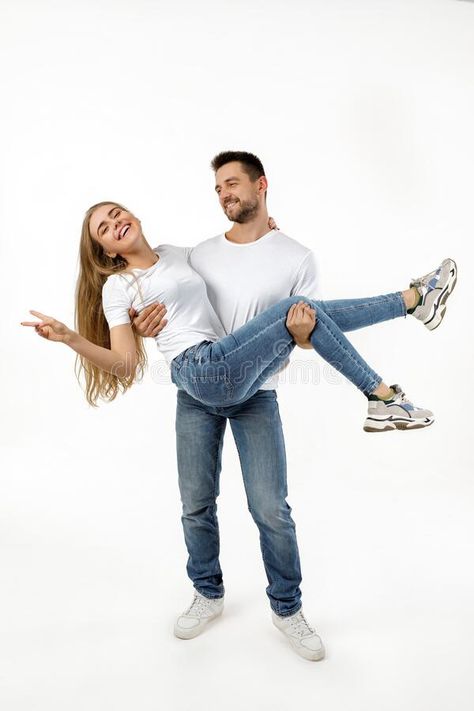 Man holding girlfriend on his arms. On white background royalty free stock photography Holding Someone In Arms Reference, Holding Girlfriend In Arms, Holding In Arms Reference, Holding Arms Out Reference, Holding Arm Pose Reference, Person Holding Hand Out, Arm Over Shoulder Pose Reference Couple, Holding Person In Arms Reference, Person Holding Another Person Reference